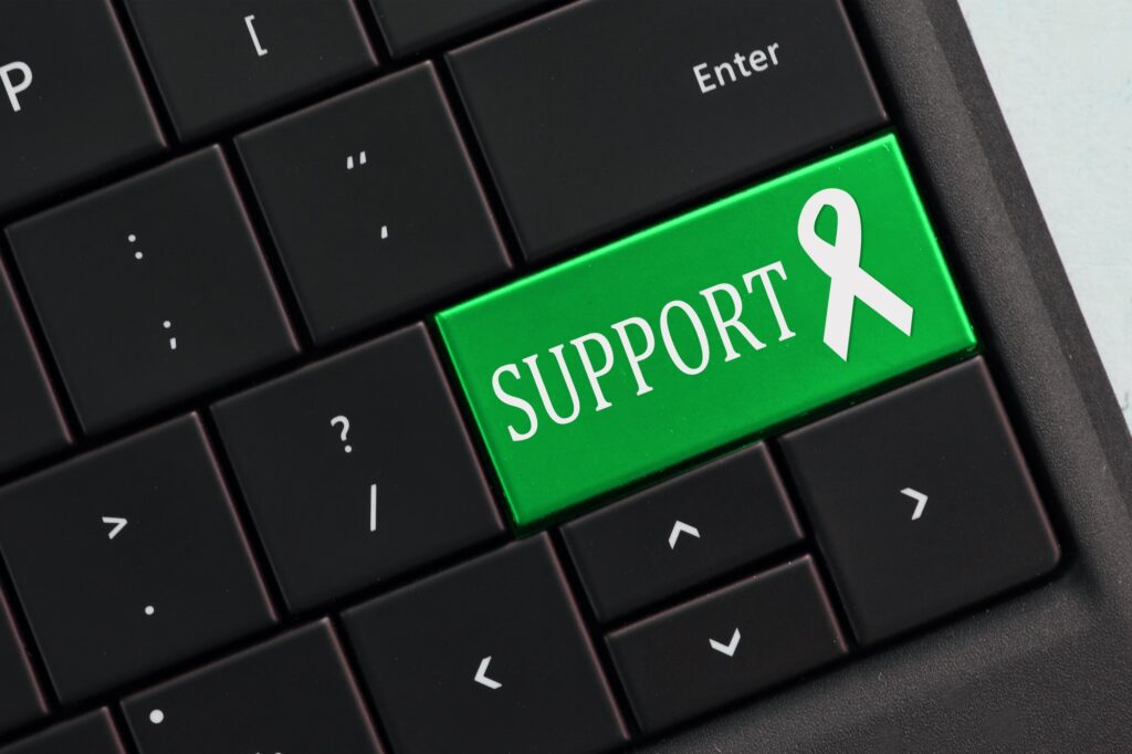 Online Support Concept - computer keyboard with GREEN support awareness ribbon.